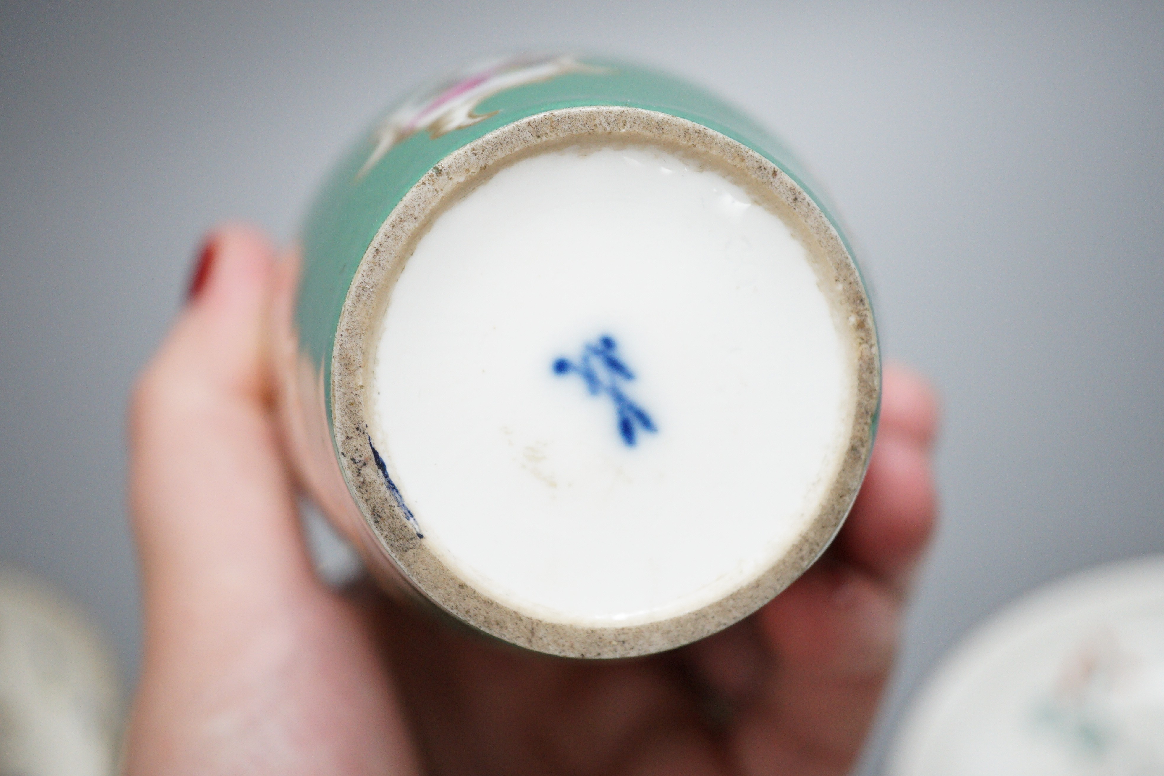 A rare Nyon porcelain slop bowl and saucer, a Meissen saucer and cylindrical pot and a pair of German saucers, red anchor marks